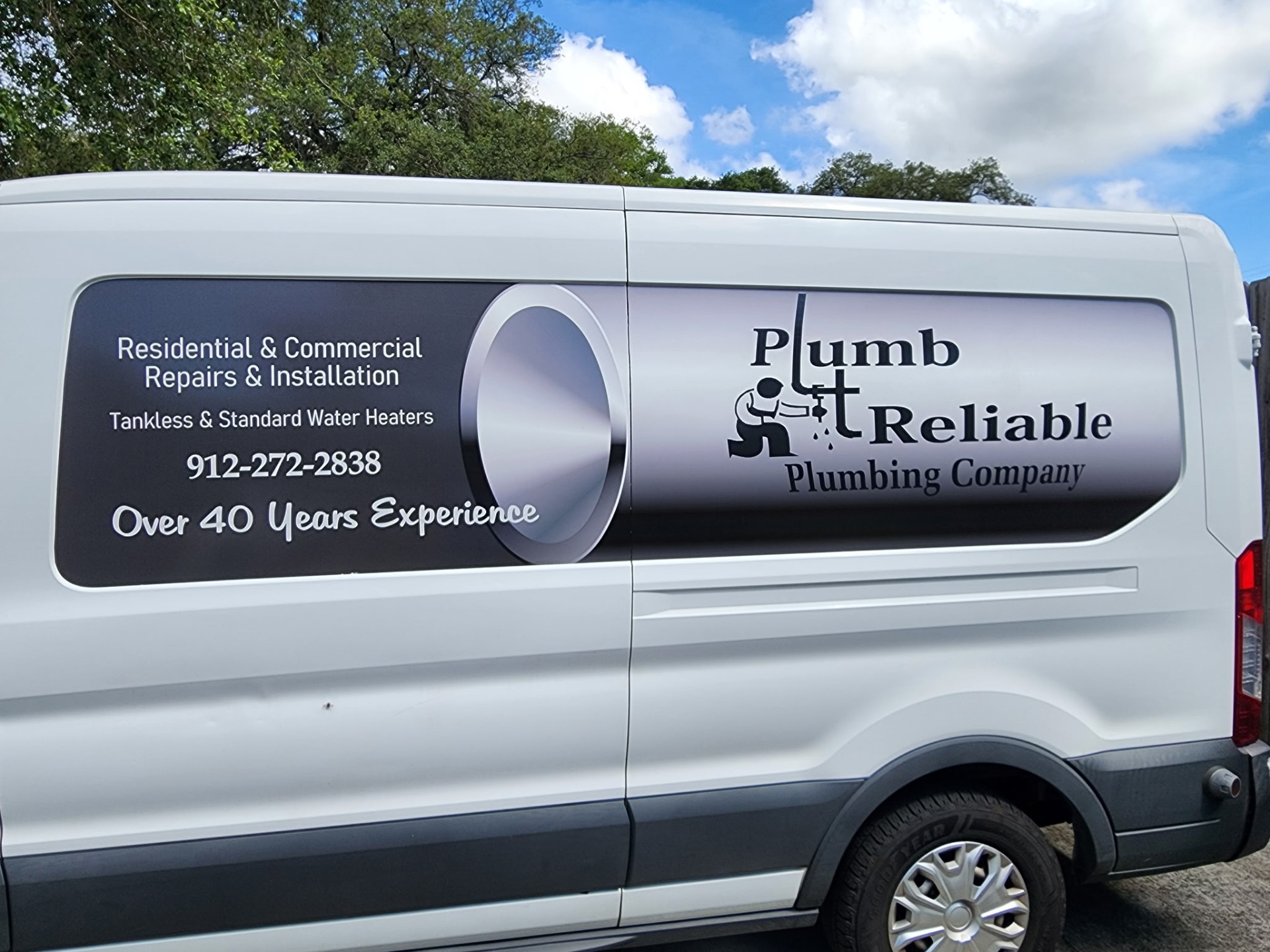 Plumb Reliable father and son plumbing team beside their service van